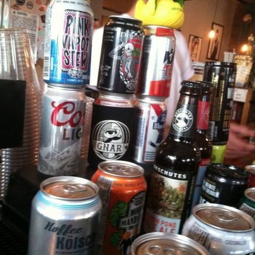A brewer working on a keg of craft beer.