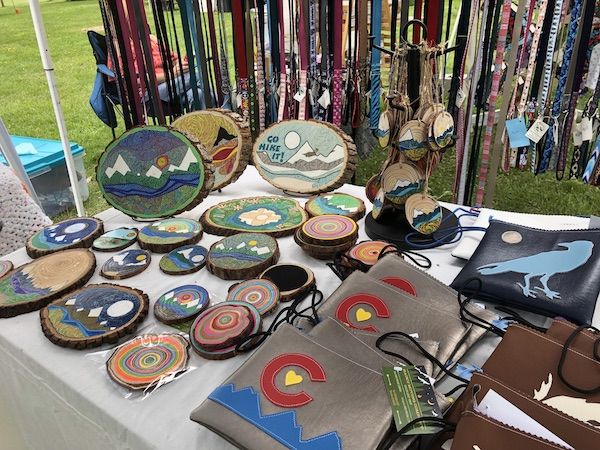 People enjoying meeting at the food stands at Ridgway Farmers Market